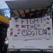 An der Rückwärtigen Klappe des Lautsprecherwagens hängt ein Transparent mit dem Slogan "Fight the Cis-tem" und vielen verschiedenen Prideflags
